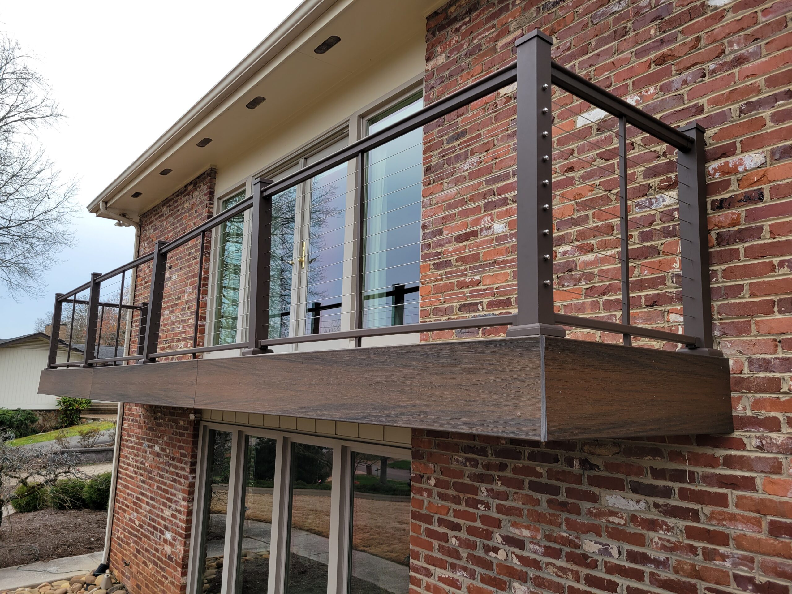 Cantilever deck with composite decking and facia and a cable railing